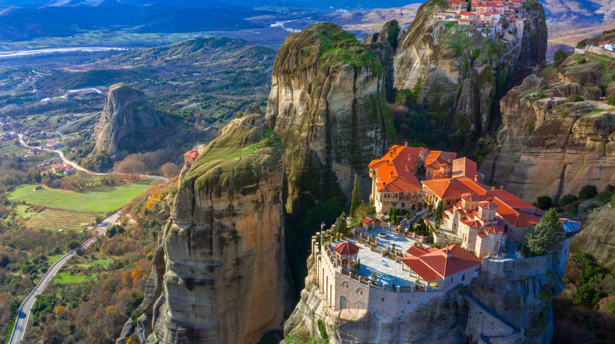 Roussanou Monastery at sunset, Greece. Geological formations of big rocks with Monasteries  on top of them.